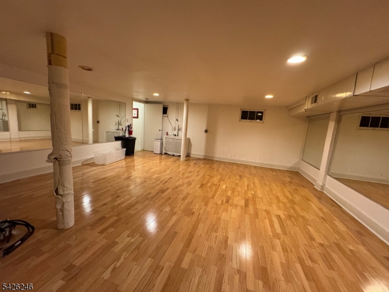630 Valley Road Gillette, NJ 07933 - Photo 15 of 30 a view of a big room with wooden floor and a window
