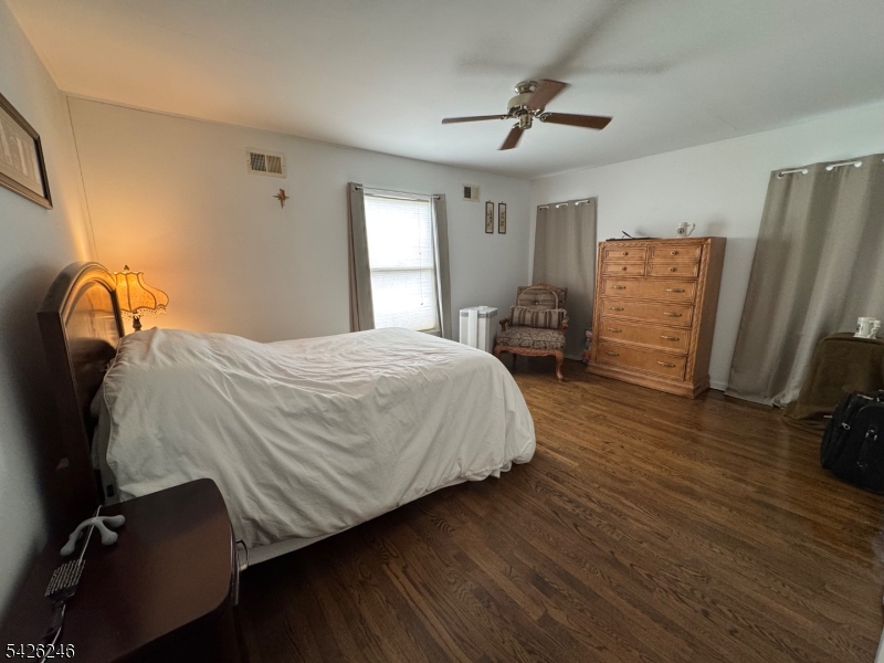 630 Valley Road Gillette, NJ 07933 - Photo 25 of 30 a bedroom with a bed closet and wooden floor