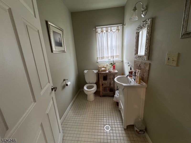 630 Valley Road Gillette, NJ 07933 - Photo 9 of 30 a bathroom with a sink a toilet and a mirror