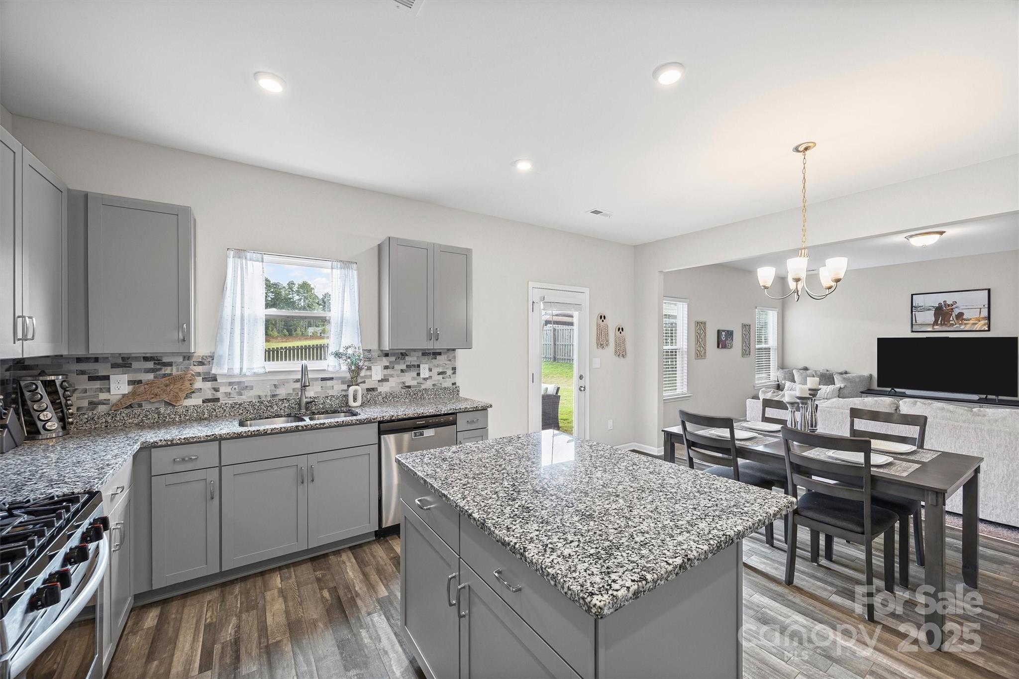 328 Cold Crk Way Mount Holly, NC 28120 - Photo 4 of 24 a kitchen with lots of counter space sink and chairs