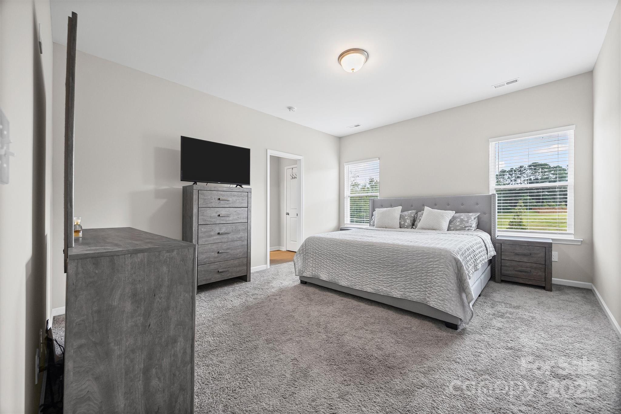 328 Cold Crk Way Mount Holly, NC 28120 - Photo 8 of 24 a bedroom with a bed and a television