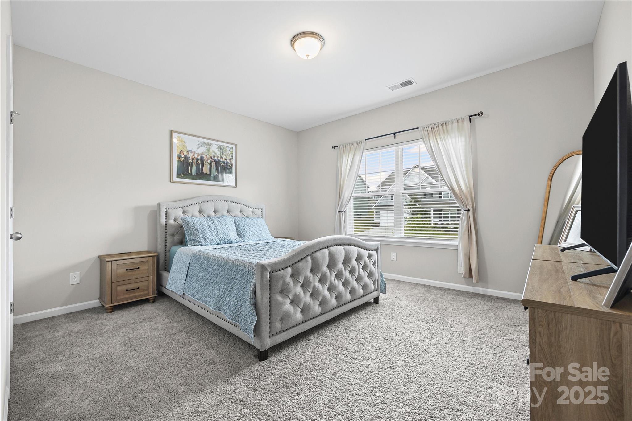 328 Cold Crk Way Mount Holly, NC 28120 - Photo 10 of 24 a spacious bedroom with a bed and a flat screen tv