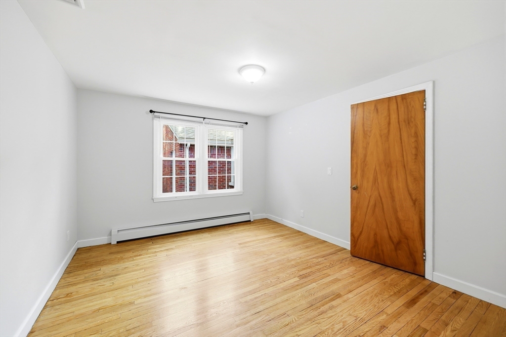 130 Connecticut Avenue Springfield, MA 01107 - Photo 29 of 40 a view of an empty room with wooden floor and a window