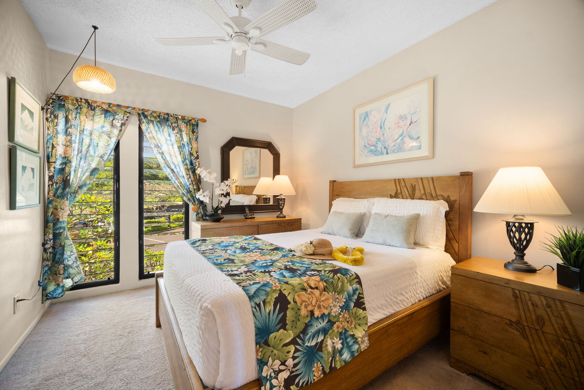 4460 Nehe Road, Unit 203 Lihue, HI 96766 - Photo 13 of 26 a bed room with a bed and a chandelier