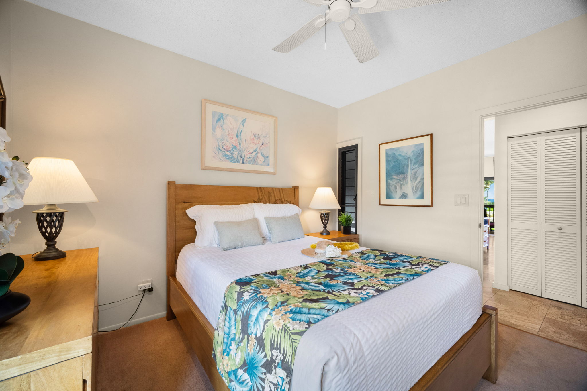 4460 Nehe Road, Unit 203 Lihue, HI 96766 - Photo 16 of 26 a bedroom with a bed and a lamp