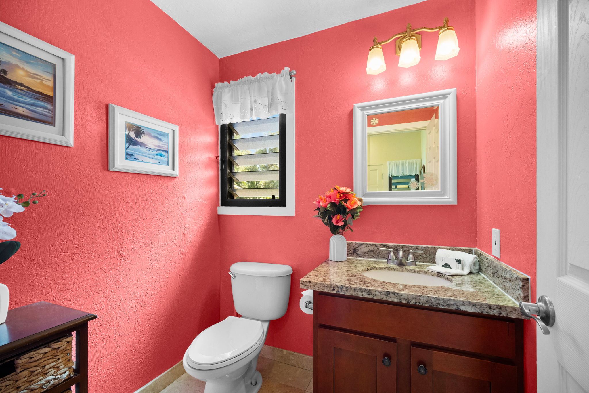 4460 Nehe Road, Unit 203 Lihue, HI 96766 - Photo 17 of 26 a bathroom with a granite countertop toilet sink and mirror