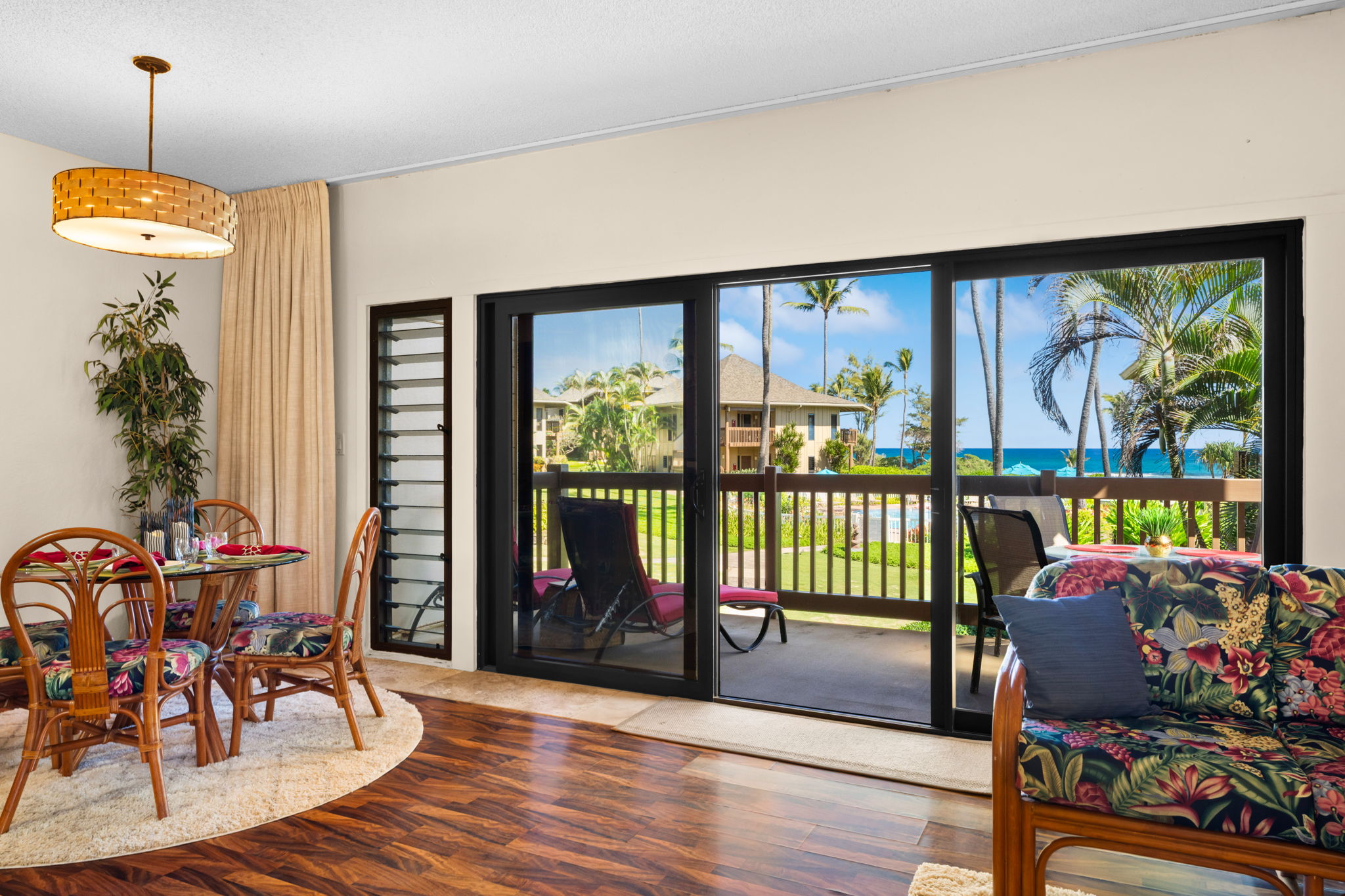 4460 Nehe Road, Unit 203 Lihue, HI 96766 - Photo 2 of 26 a living room with furniture and a floor to ceiling window