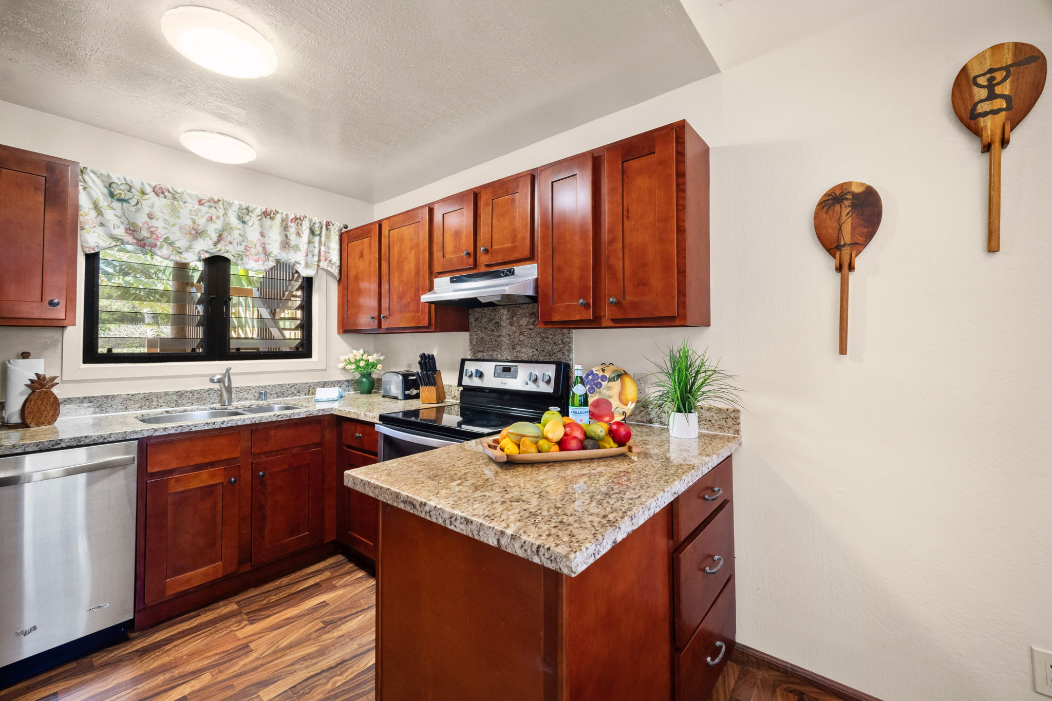 4460 Nehe Road, Unit 203 Lihue, HI 96766 - Photo 6 of 26 a kitchen with stainless steel appliances granite countertop a sink stove and cabinets