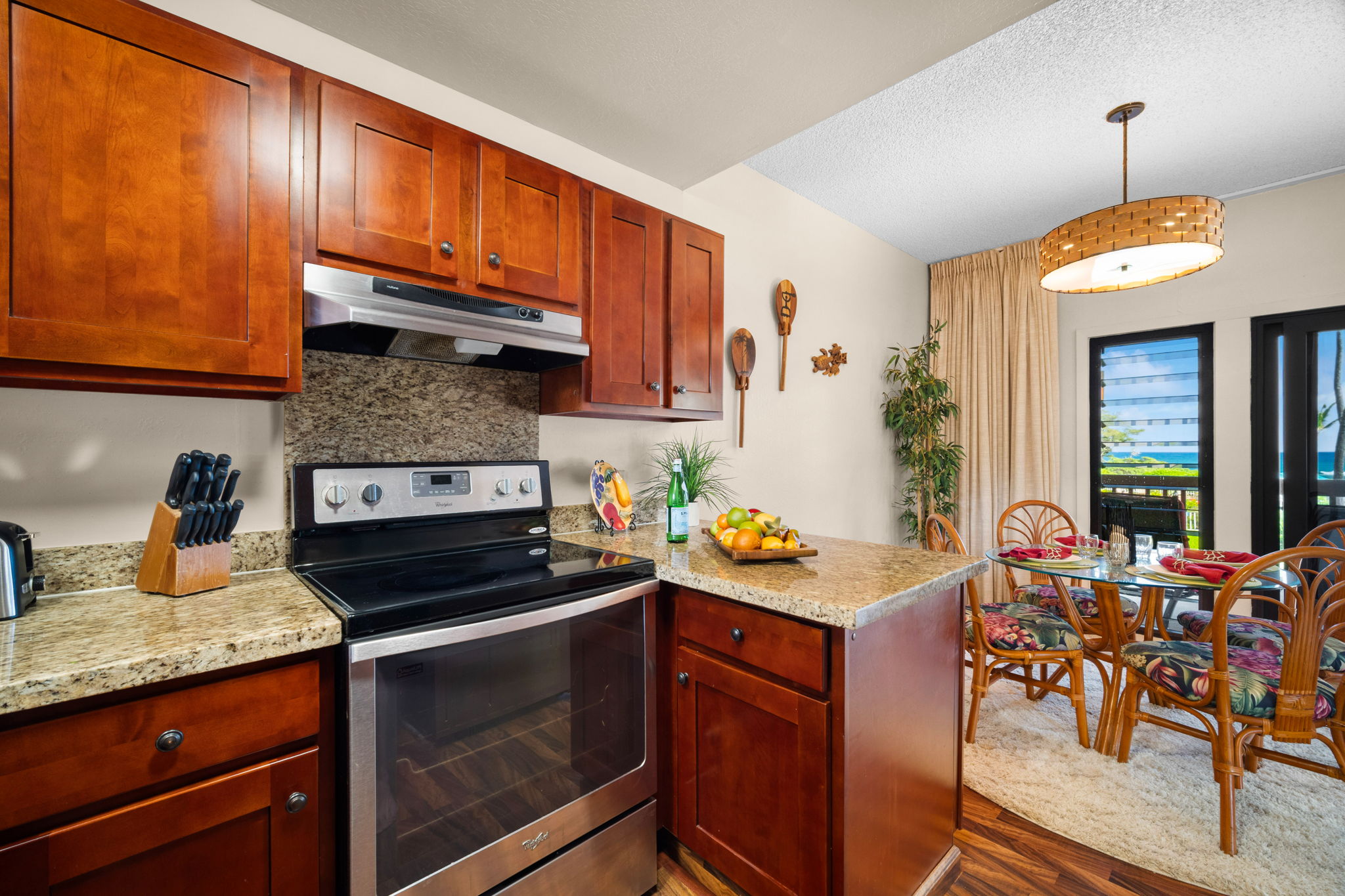 4460 Nehe Road, Unit 203 Lihue, HI 96766 - Photo 8 of 26 a kitchen with stainless steel appliances granite countertop a stove a sink and a microwave