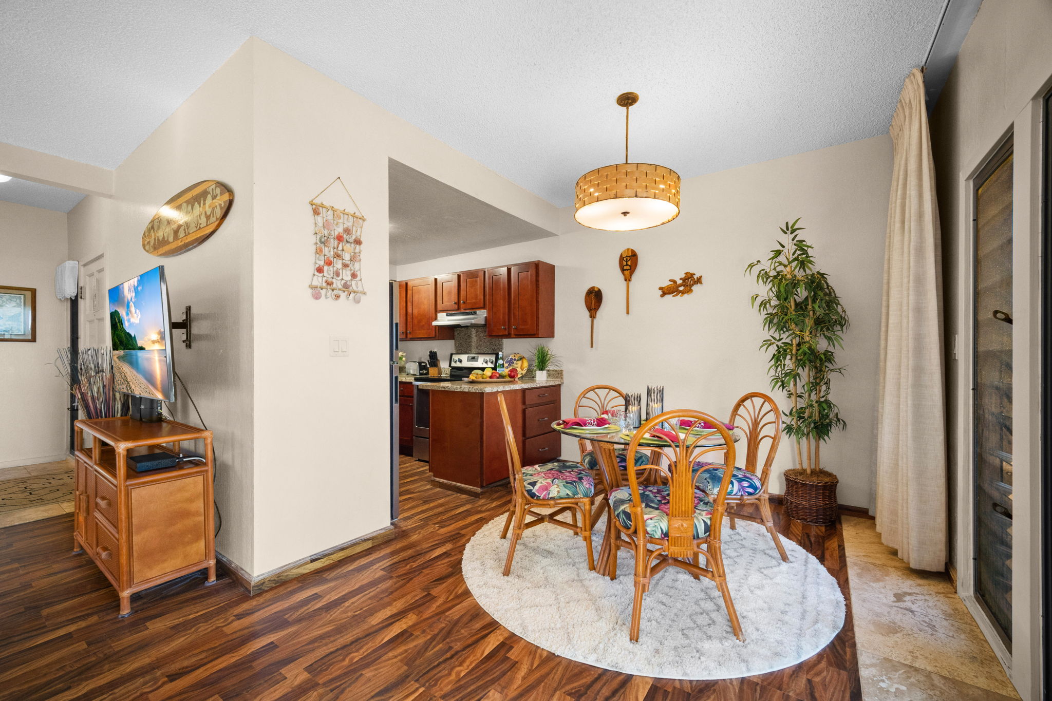 4460 Nehe Road, Unit 203 Lihue, HI 96766 - Photo 9 of 26 a view of a dining room with furniture wooden floor and chandelier