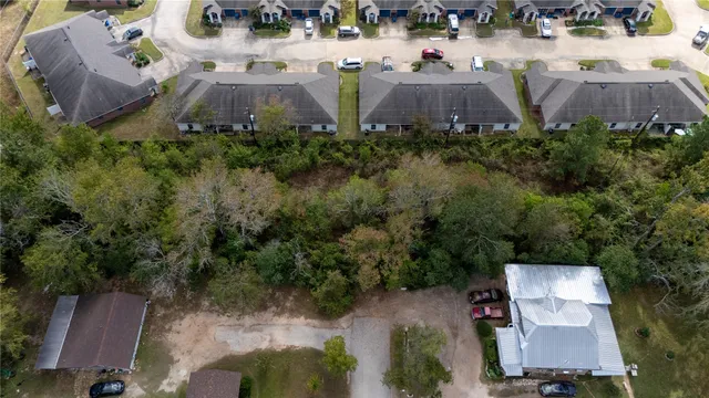 an aerial view of a house with pool and garden