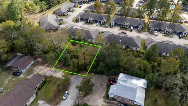 an aerial view of multiple houses with yard