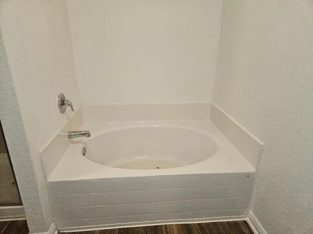 a bathroom with granite countertop double vanity and a mirror