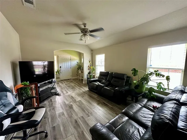 a living room with furniture and a flat screen tv