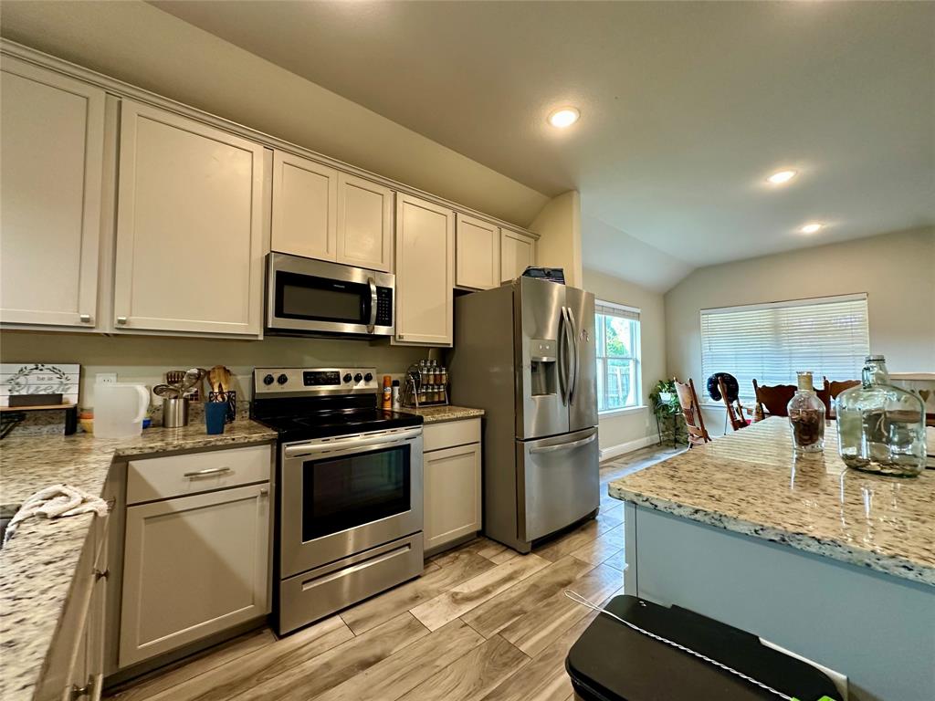 2801 Stuart Drive Fort Worth, TX 76104 - Photo 16 of 39 a kitchen with stainless steel appliances granite countertop a refrigerator stove microwave and sink