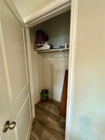 a room with a wooden floor and a window