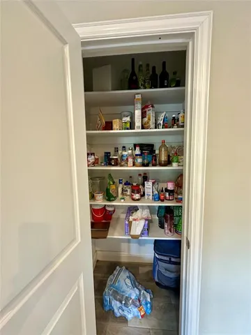 a room with a wooden floor and shelf