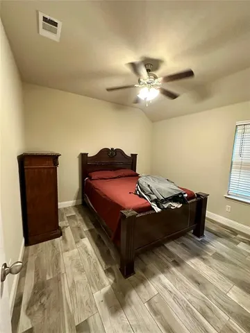 a bedroom with a bed and window