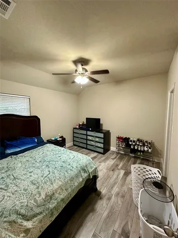 a bedroom with two beds and a chandelier