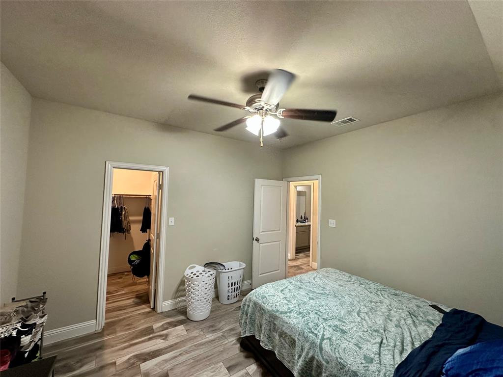 2801 Stuart Drive Fort Worth, TX 76104 - Photo 26 of 39 a bedroom with bed and wooden floor