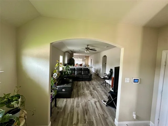 a view of a room with wooden floor