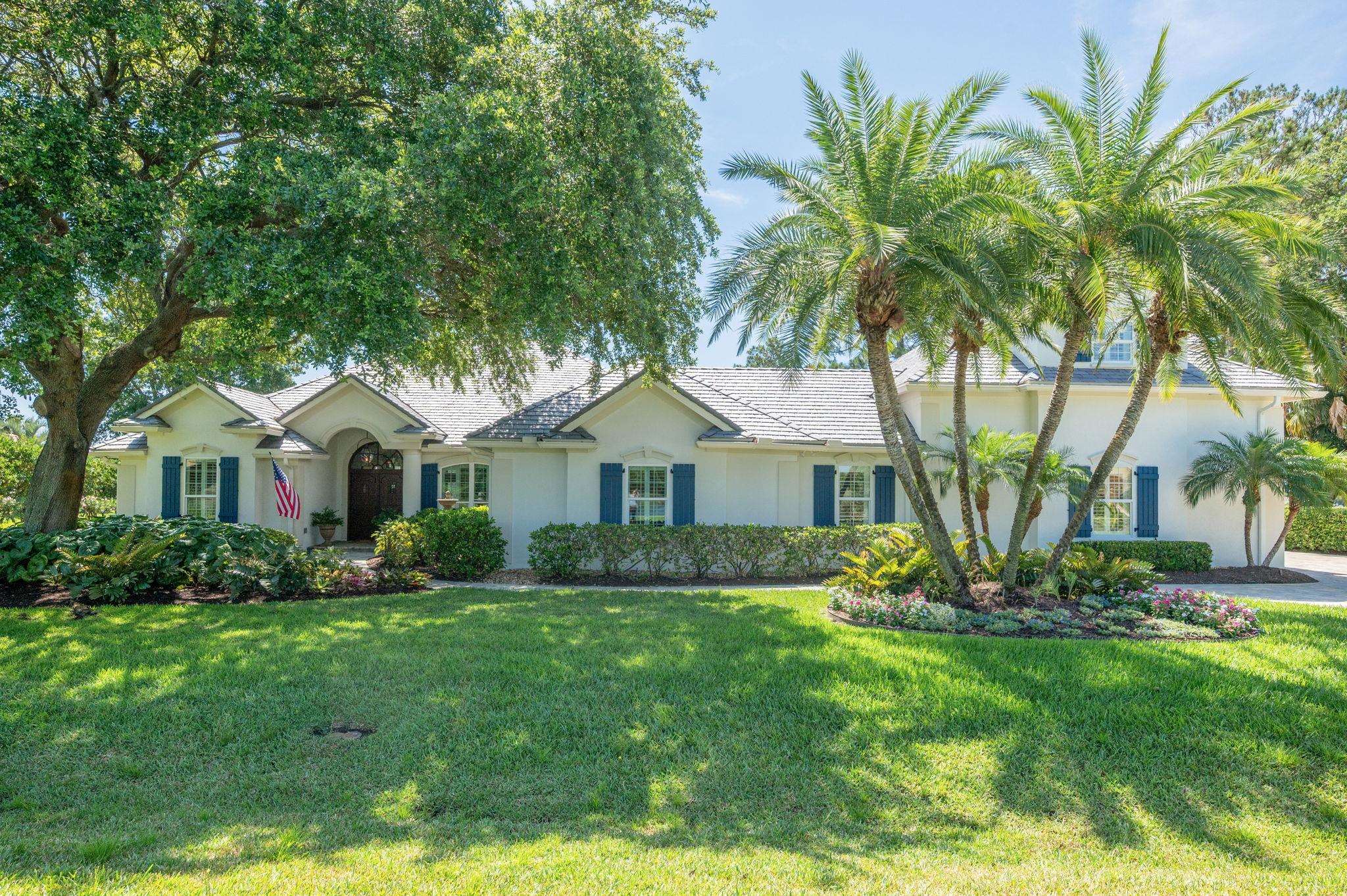 248 Marshside Drive St. Augustine, FL 32080 - Photo 2 of 78 a front view of a house with a garden and trees
