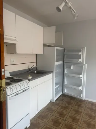 a kitchen with a stove and a refrigerator