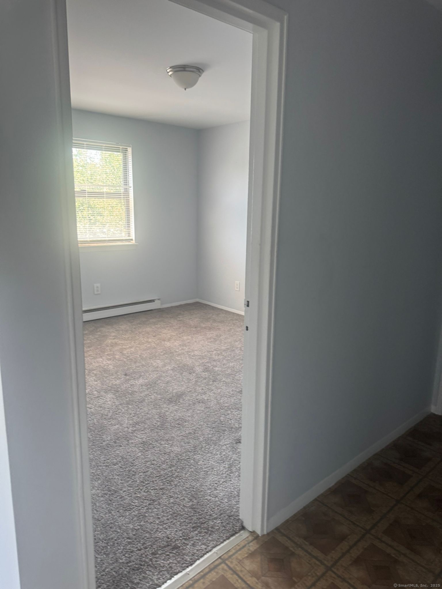 217 Hollister Avenue, Unit C3 Bridgeport, CT 06607 - Photo 3 of 7 an empty room with windows