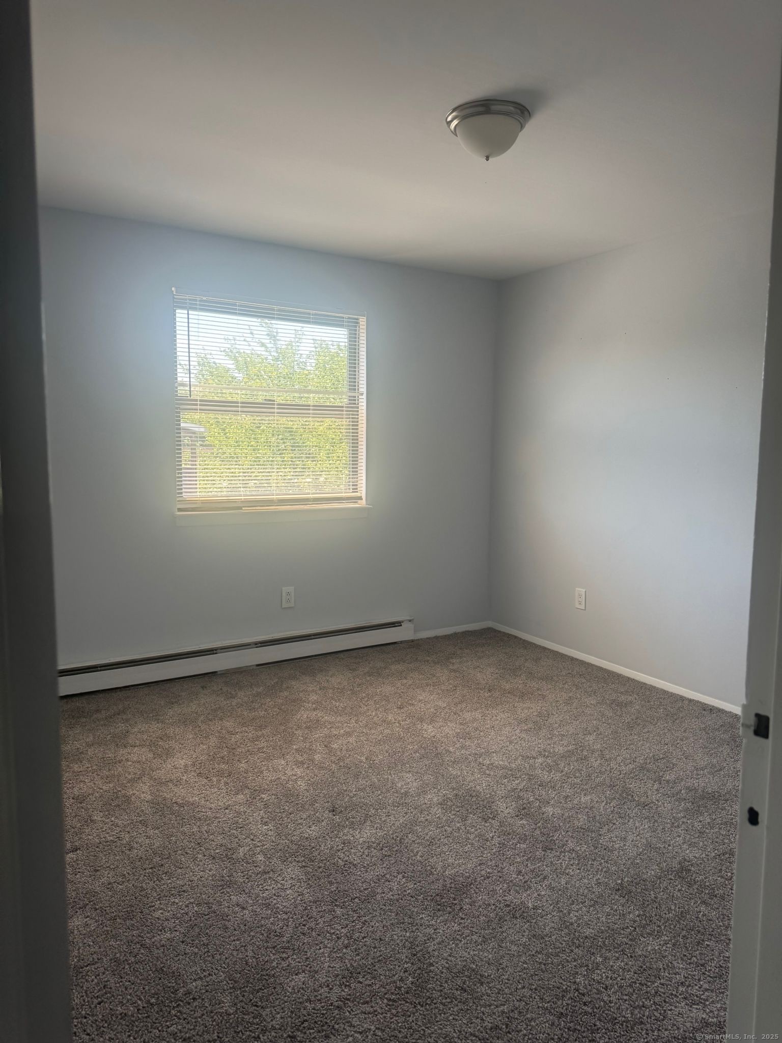 217 Hollister Avenue, Unit C3 Bridgeport, CT 06607 - Photo 5 of 7 an empty room with a window