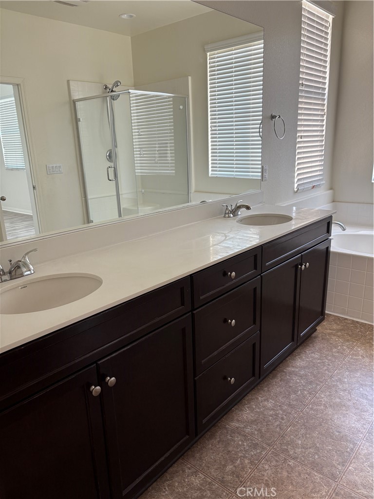 28434 Sunflower Street Highland, CA 92346 - Photo 12 of 22 a bathroom with double vanity sink a mirror a and a window