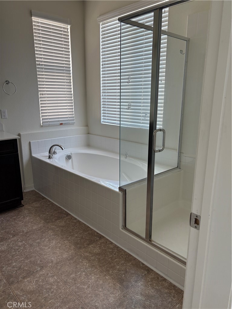 28434 Sunflower Street Highland, CA 92346 - Photo 13 of 22 a bathroom with a bathtub and a window