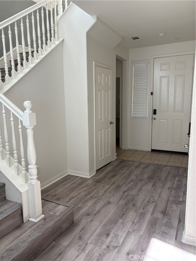 28434 Sunflower Street Highland, CA 92346 - Photo 18 of 22 a view of an entryway with wooden floor