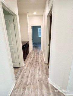 28434 Sunflower Street Highland, CA 92346 - Photo 19 of 22 a view of a hallway with wooden floor and staircase