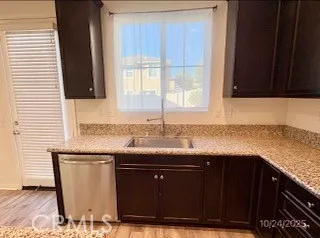 a kitchen with granite countertop a sink and a cabinets