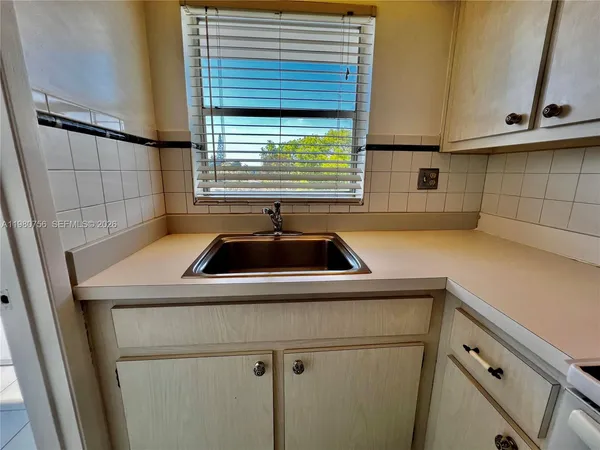 a stove top oven sitting inside of a kitchen