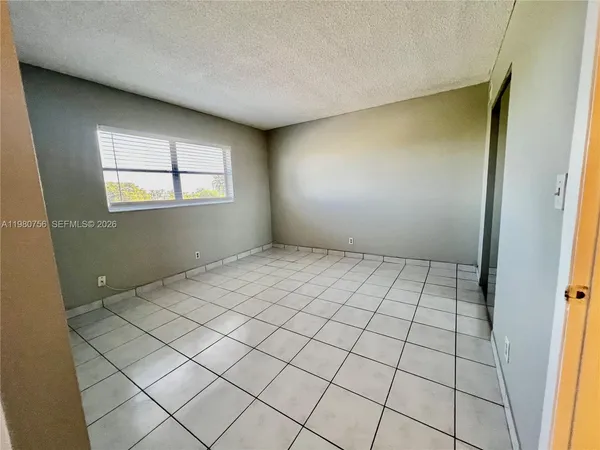 a view of an empty room and window