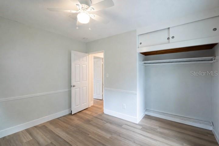 314 4th Avenue Southwest Ruskin, FL 33570 - Photo 16 of 30 an empty room with wooden floor and fan