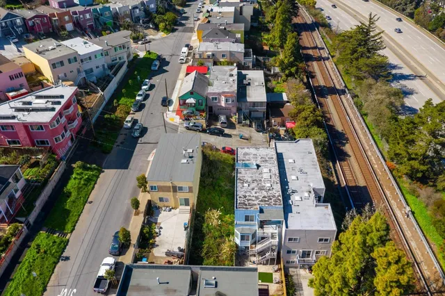 an aerial view of houses with outdoor space