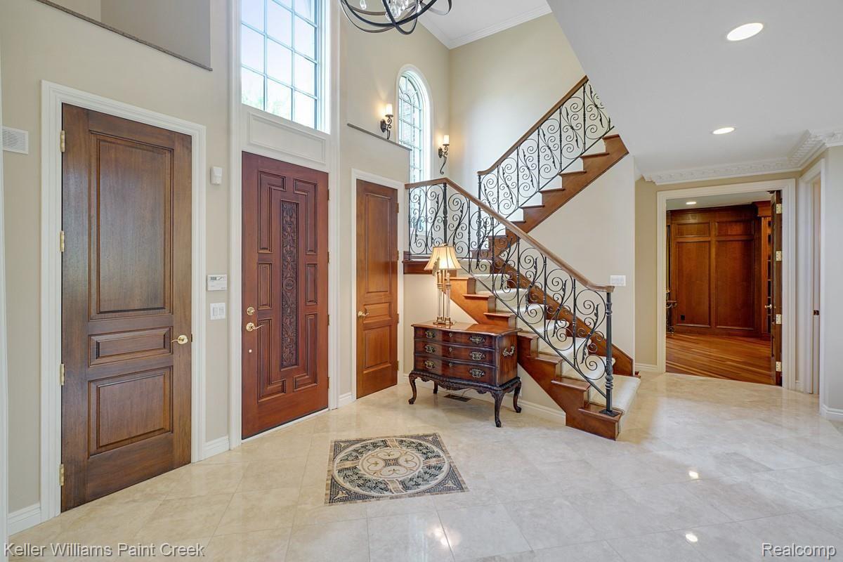 4902 Crestone Way Rochester, MI 48306 - Photo 17 of 70 The impressive foyer entrance with marble flooring with detailing, custom iron staircase and modern fixtures.