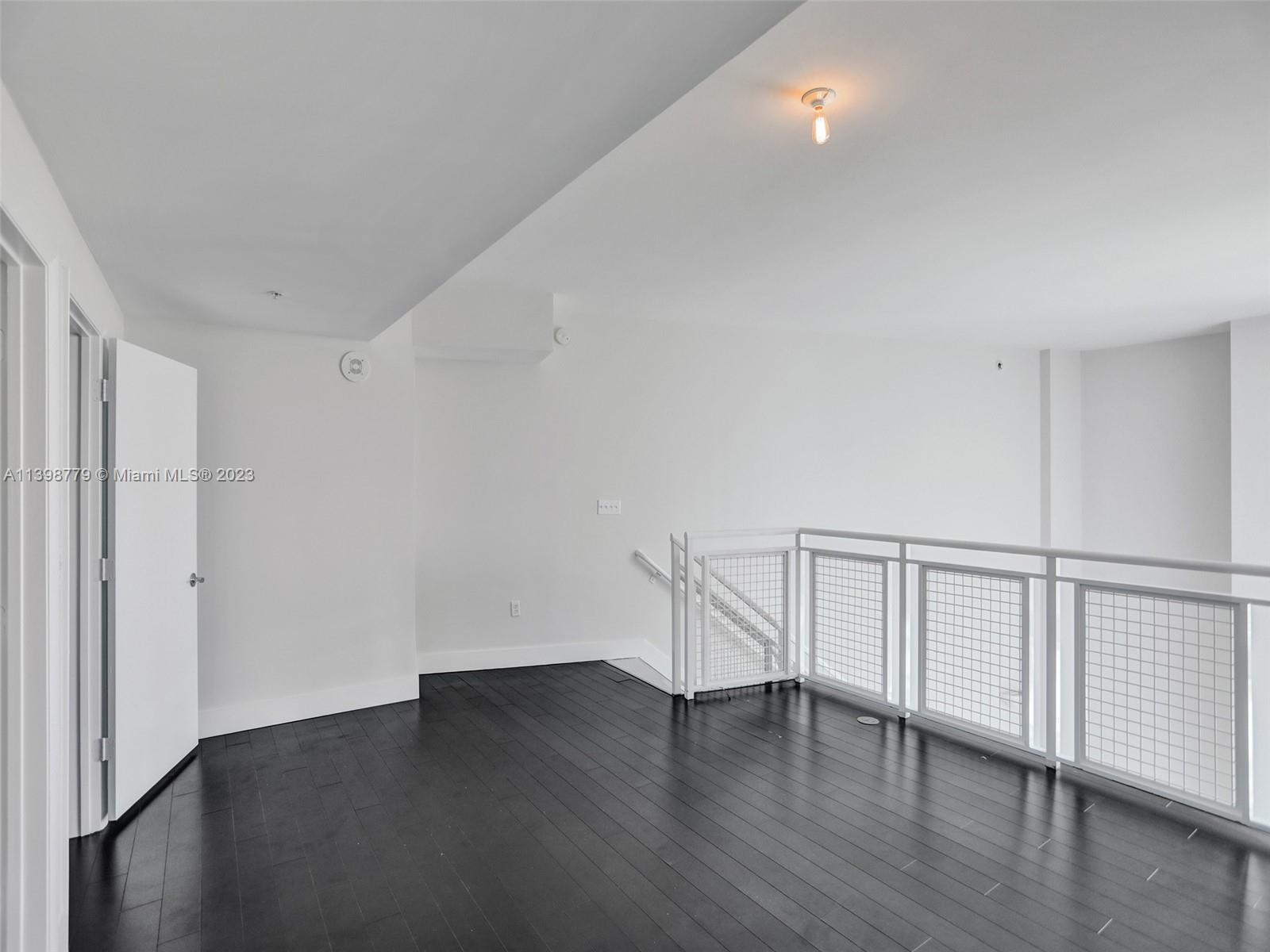 244 Biscayne Boulevard, Unit 439 Miami, FL 33132 - Photo 17 of 49 a view of an empty room with wooden floor