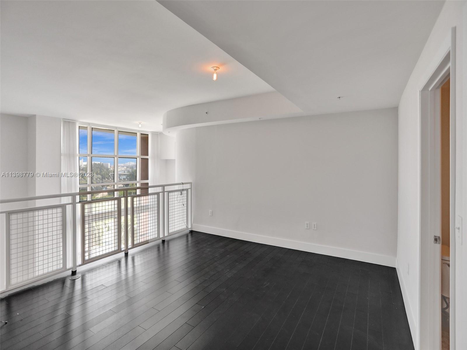 244 Biscayne Boulevard, Unit 439 Miami, FL 33132 - Photo 18 of 49 a view of a kitchen with wooden floor and a window