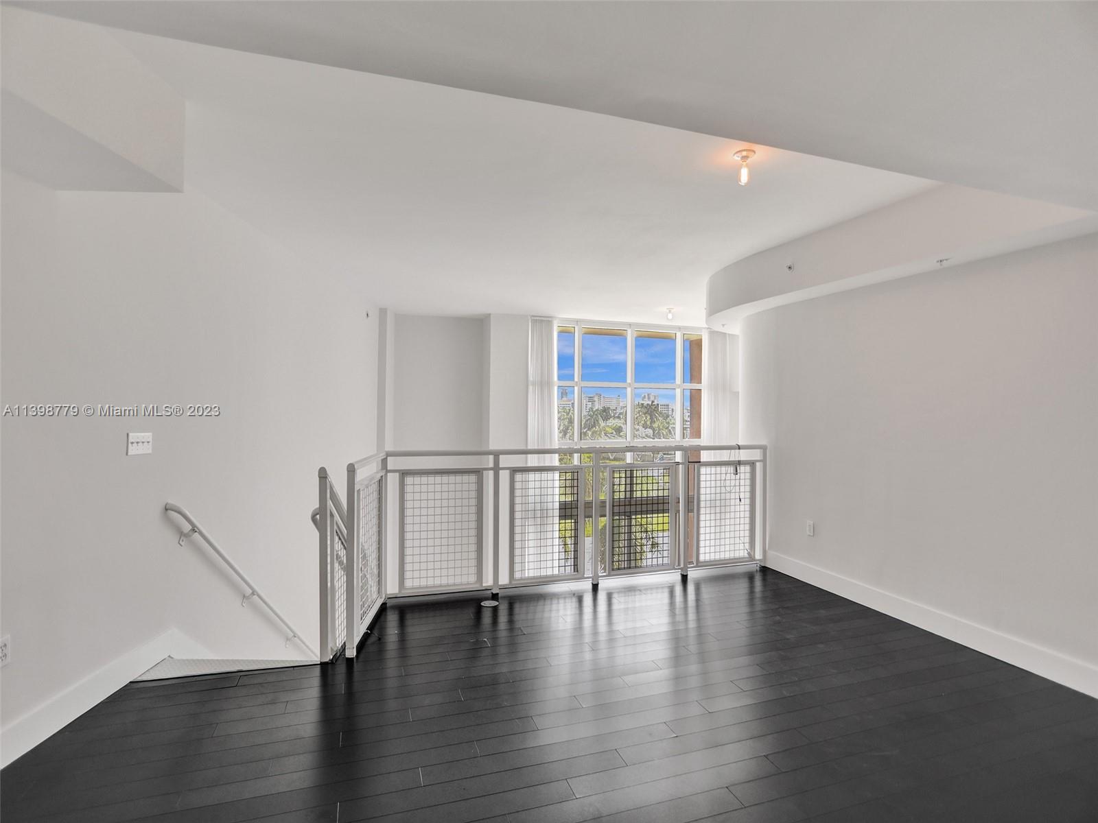 244 Biscayne Boulevard, Unit 439 Miami, FL 33132 - Photo 19 of 49 a view of empty room with wooden floor
