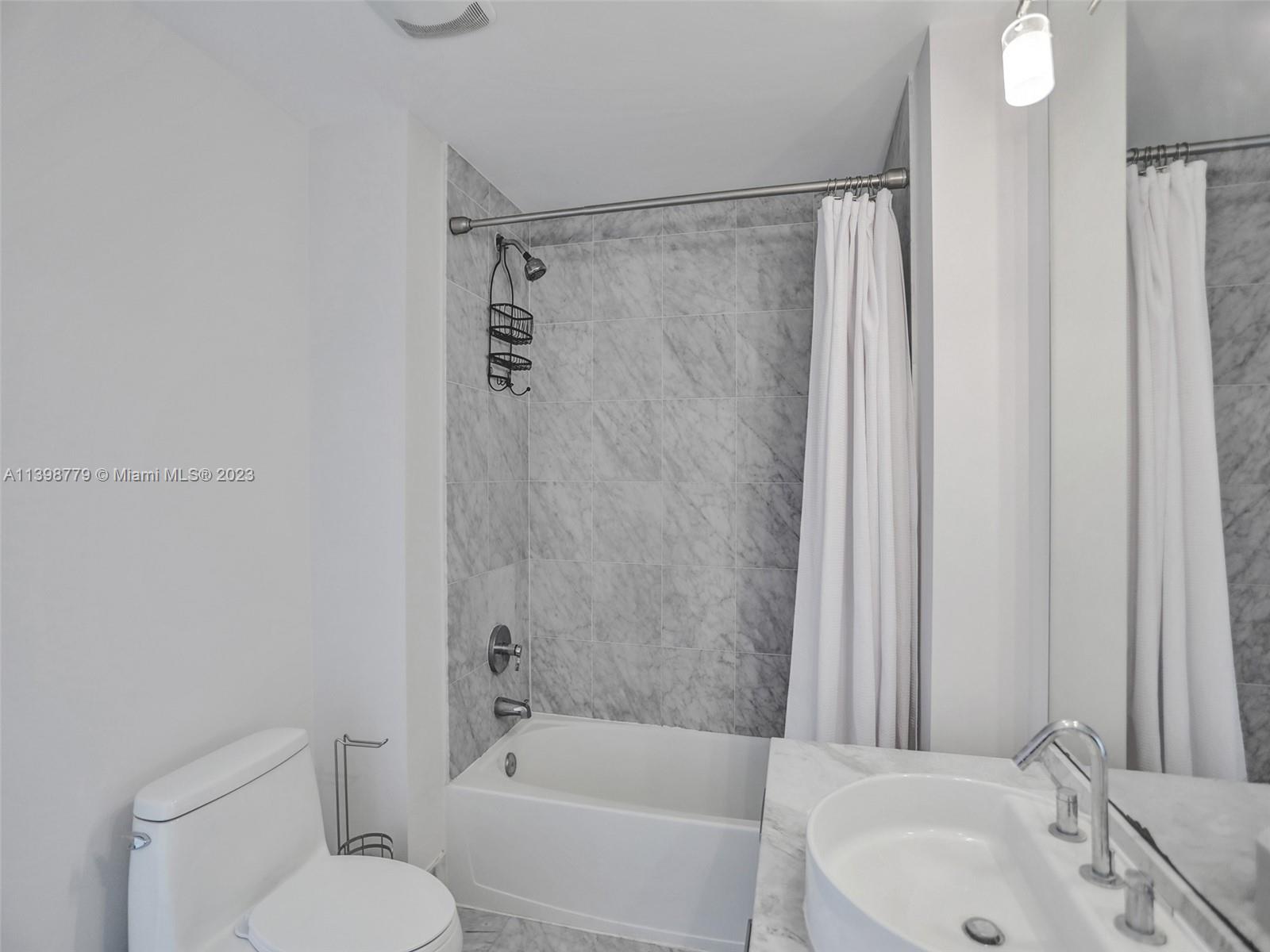 244 Biscayne Boulevard, Unit 439 Miami, FL 33132 - Photo 25 of 49 a bathroom with a sink toilet and shower