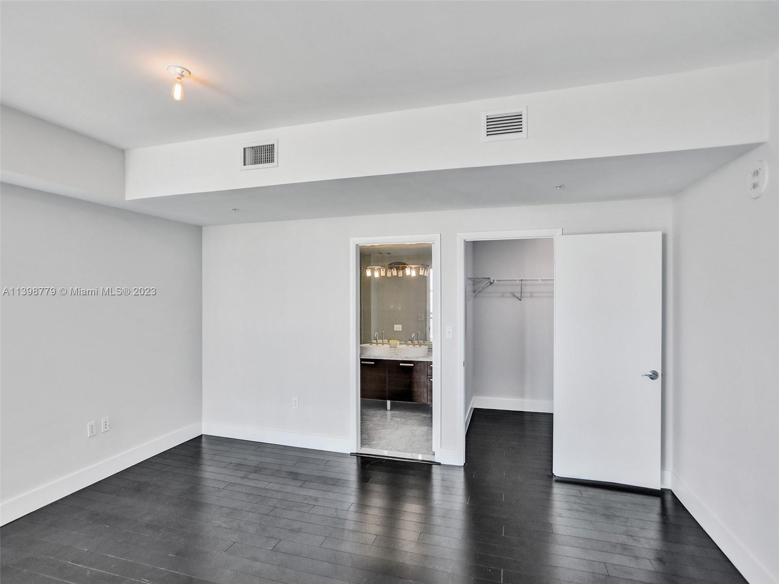 244 Biscayne Boulevard, Unit 439 Miami, FL 33132 - Photo 27 of 49 a view of a big room with wooden floor and windows