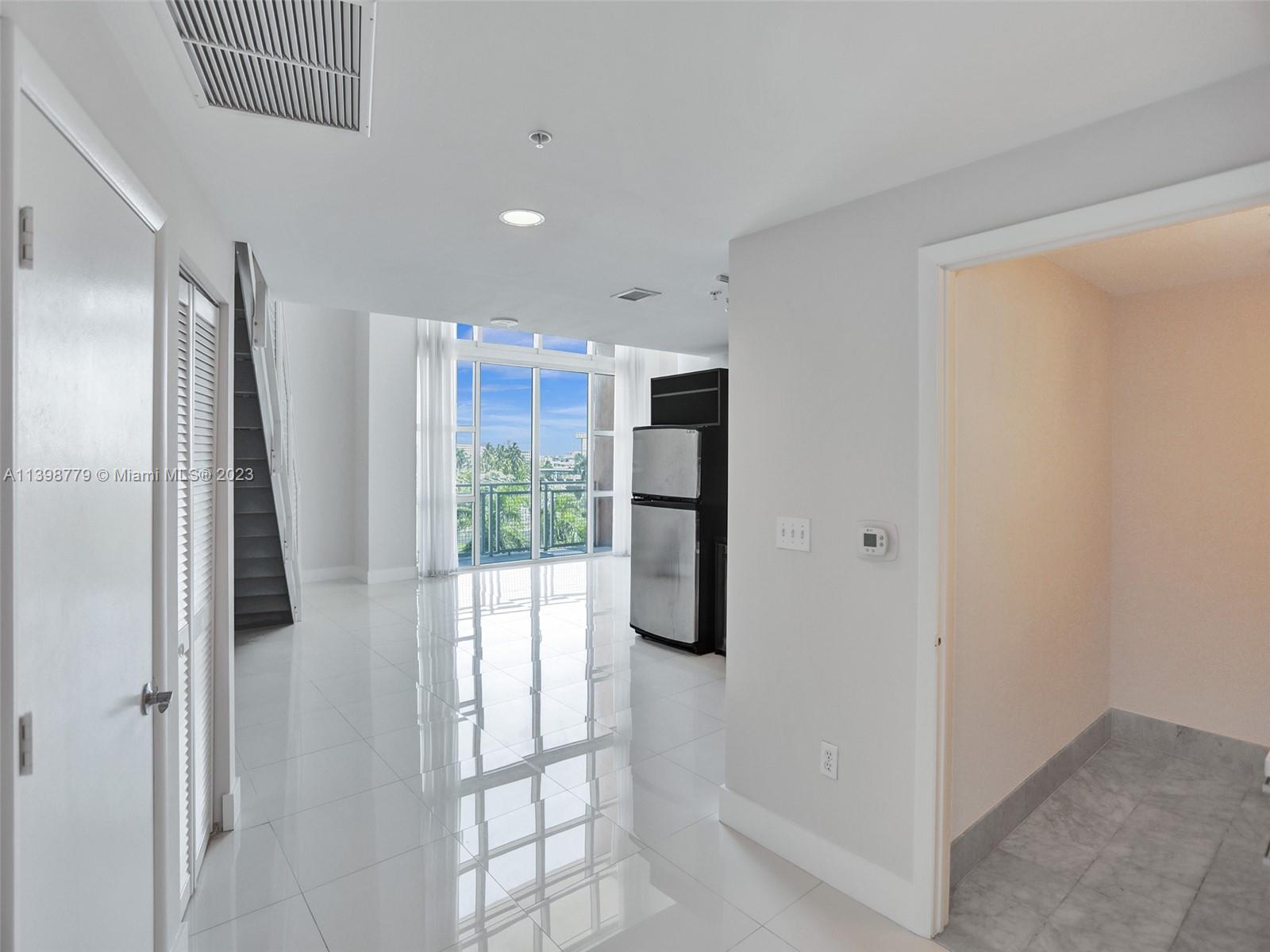 244 Biscayne Boulevard, Unit 439 Miami, FL 33132 - Photo 3 of 49 a view of a kitchen with a refrigerator and a window