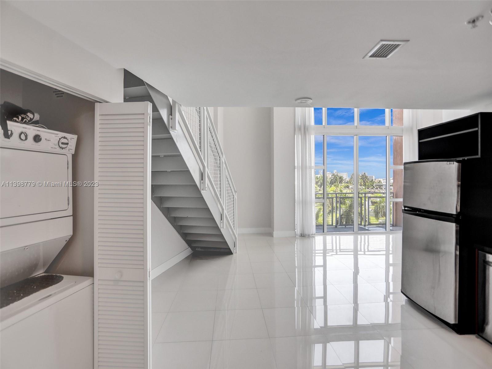 244 Biscayne Boulevard, Unit 439 Miami, FL 33132 - Photo 7 of 49 a white refrigerator freezer and a stove sitting inside of a kitchen