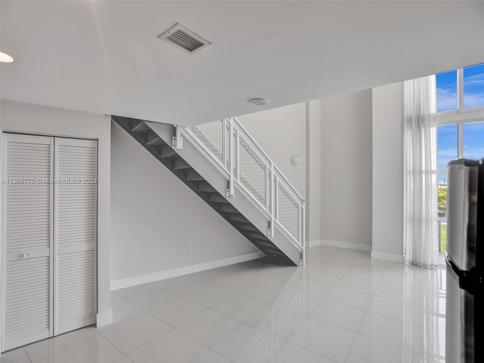 244 Biscayne Boulevard, Unit 439 Miami, FL 33132 - Photo 10 of 49 a view of a livingroom with a staircase