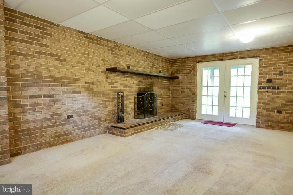 121 Plum Point Road Huntingtown, MD 20639 - Photo 17 of 30 a view of an empty room with a fireplace
