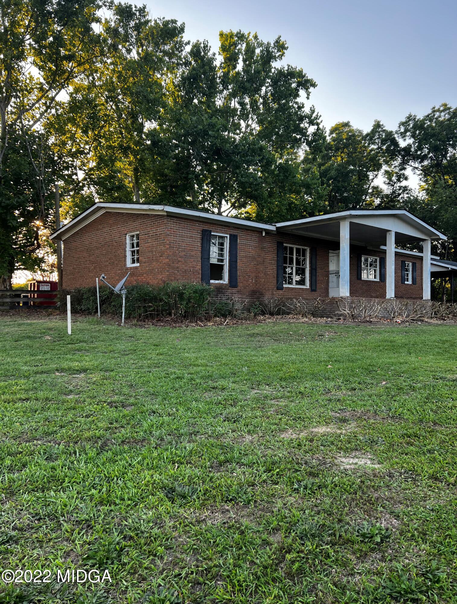 a view of a house with yard and a tree