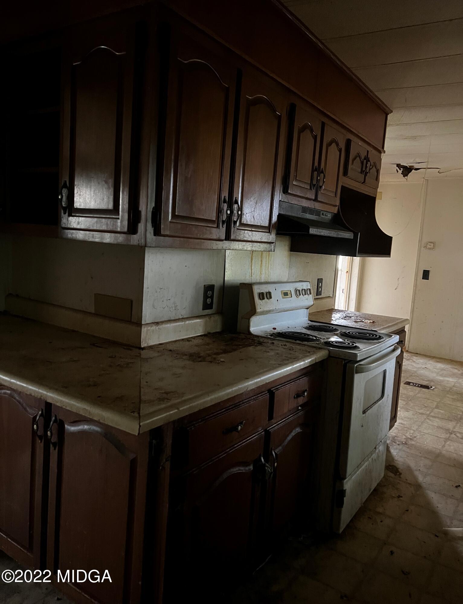 6509 Skipper Road Macon, GA 31216 - Photo 15 of 28 a kitchen with stainless steel appliances granite countertop a stove and a microwave